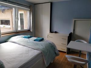 a bedroom with a bed and a desk and a window at Self Catering Studio Flat in Edinburgh