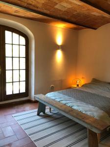 a bedroom with a bed and a large window at Podere Zelmira in Sinalunga