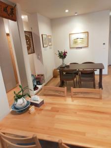a dining room and living room with a table and chairs at Deer hostel-外国人予約限定 in Nara +10 photos