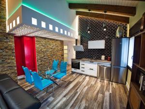 a kitchen with a couch and blue chairs in a kitchen at Apartamentos Valle de Ordesa-Torla in Torla-Ordesa