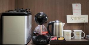 a counter with a coffee maker and a toaster at Ramada by Wyndham Jeju City Hall in Jeju