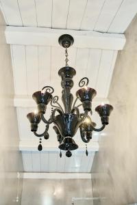 a chandelier hanging from a ceiling in a room at Simone Cenedese Murano Apartments - Ambra in Venice