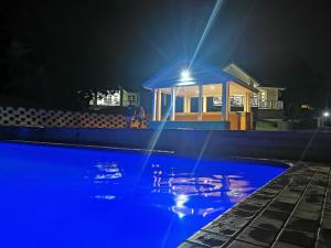 a swimming pool at night with a gazebo at 20 Montego Bay - Caribbean Estates in Port Edward