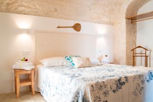 A bed or beds in a room at Dimore Angiulli - Trulli di Charme