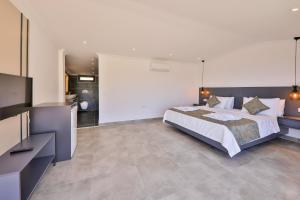 A bed or beds in a room at Luxury 5 bedroom villa with heated infinity pool & amazing sea views