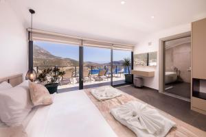 A bed or beds in a room at Luxury 5 bedroom villa with heated infinity pool & amazing sea views