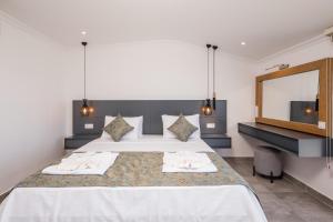 A bed or beds in a room at Luxury 5 bedroom villa with heated infinity pool & amazing sea views