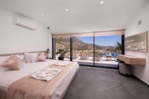 A bed or beds in a room at Luxury 5 bedroom villa with heated infinity pool & amazing sea views