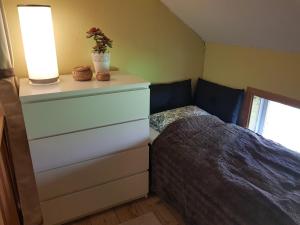 a bedroom with a dresser and a bed in it at Det lilla huset in Nora