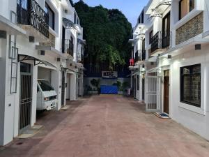 an alley between two buildings with a car parked in it at Kdc Homes in Puerto Princesa City