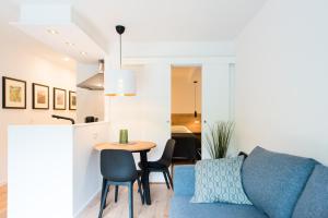 a living room with a table and chairs and a couch at Appartement HideAway Nr 96 - Amelander Kaap in Hollum