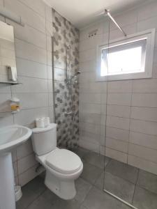 a bathroom with a toilet and a sink and a shower at Napa City Apartments in Ayia Napa