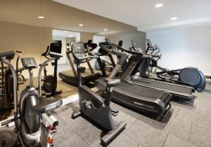 a gym with many cardio machines in a room at Leonardo Hotel Manchester Piccadilly in Manchester