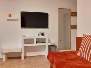 a living room with a tv on a wall at Apartment Norma in Bovec