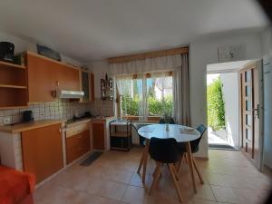 a kitchen with a table and a table and chairs at Apartment Norma in Bovec