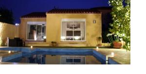 a house with a swimming pool at night at SUITE SPA PRIVATIF 66 Nord de Perpignan in Pia