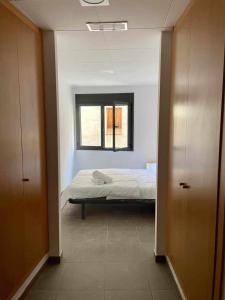 a bedroom with a bed and a window in it at Apto Los Molinos Sotano A REF 049 in Lucena del Cid