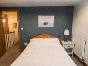 a bedroom with a large bed with a blue wall at Cedar View in Whitby
