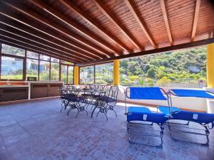 a dining room with blue chairs and a table at Rosa's house in Lipari