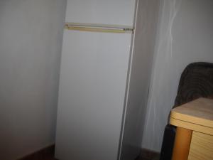 lodówka w pokoju z drewnianym stołem w obiekcie Casa Caremy w mieście Almería