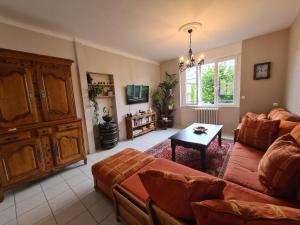 a living room with a couch and a table at Mont Naïa in Pontorson