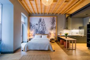 a bedroom with a bed and a large painting on the wall at Art Pera Suites in Istanbul