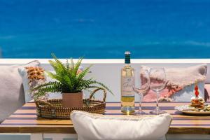 un tavolo con una bottiglia di vino e due bicchieri di Casa Perseida a Tías