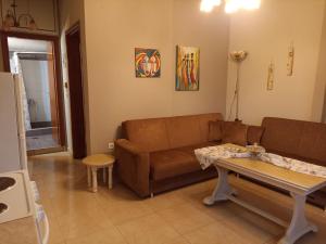a living room with a couch and a table at ΠΛΑΤΕΙΑ-PLATIA in Agios Nikolaos +18 photos