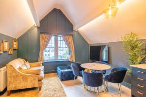 a living room with a couch and a table at The Rockefeller Apartments in Bowness-on-Windermere