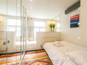 a bedroom with a glass shower and a bed at Pass the Keys - Top Floor Flat in the heart of Portobello Market, London in London