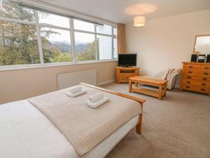 a bedroom with a bed with two towels on it at Lake House Bowness in Windermere