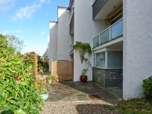 a house with a stone walkway in front of it at Lake House Bowness in Windermere