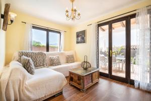 a living room with a couch and a table at Casa Sol Cala dor in Cala D'or +17 photos