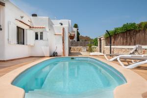 a swimming pool in front of a villa at Casa Sol Cala dor in Cala D'or