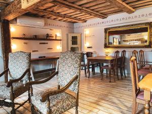 a dining room with a table and chairs and a mirror at SĪMANIS Boutique Hotel in Kuldīga +46 photos