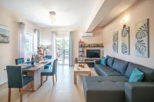 a living room with a couch and a table at Tina's Suite by "elite" in Plános