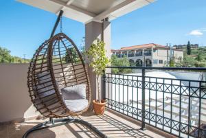 a hanging chair on a balcony with a view at Tina's Suite in Planos