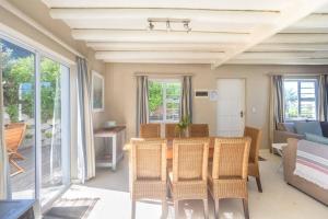 a living room with a table and chairs and a couch at Oyster Catcher in Cape St Francis