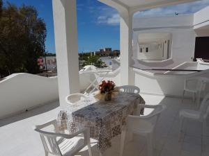 a table and chairs on a balcony with a view at Gallipoli Mancaversa Futura Vacanza Andrea in Marina di Mancaversa