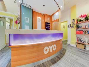 an office lobby with an ovo reception counter at OYO Grantly Hotel in London