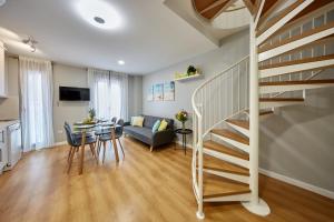 a living room with a staircase and a dining room at Apart-hotel Happy Life in Alicante