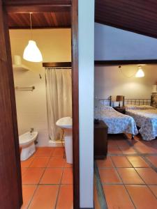 a room with two beds and a bathroom at Casa do Faial - Braga in Braga