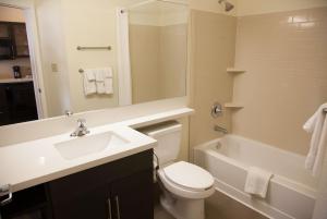 a white toilet sitting next to a sink in a bathroom at Candlewood Suites Alexandria, an IHG Hotel in Alexandria