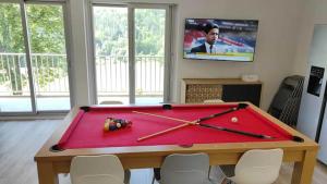 a room with a pool table with avertisement at Lelexine in Lélex