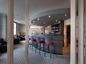 a bar in a restaurant with red stools at Hotel Best Western City Centre in Brussels