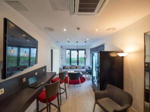 a living room with a table and chairs and a couch at Hotel Best Western City Centre in Brussels