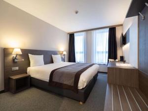 a hotel room with a large bed and a window at Hotel Best Western City Centre in Brussels