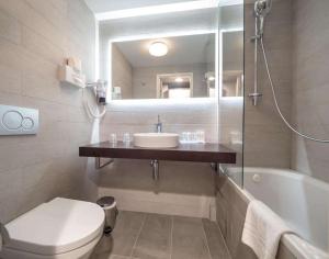 a bathroom with a sink and a toilet and a mirror at Hotel Best Western City Centre in Brussels