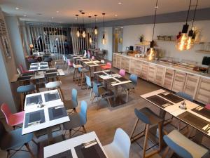a restaurant with tables and chairs and a counter at Hotel Best Western City Centre in Brussels