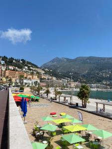 a beach with a bunch of umbrellas and a beach at Renovated studio in the heart of the Old Town in Menton
